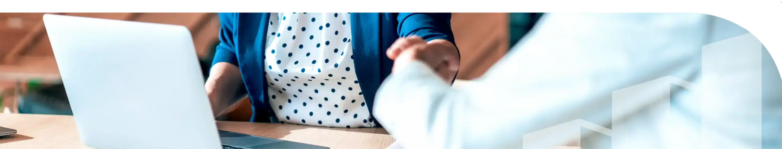 An image of two people sitting and shaking hands