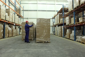 worker examining warehouse inventory