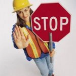 woman with a roadblock stop sign