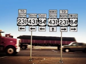 trucks on interstate with sign