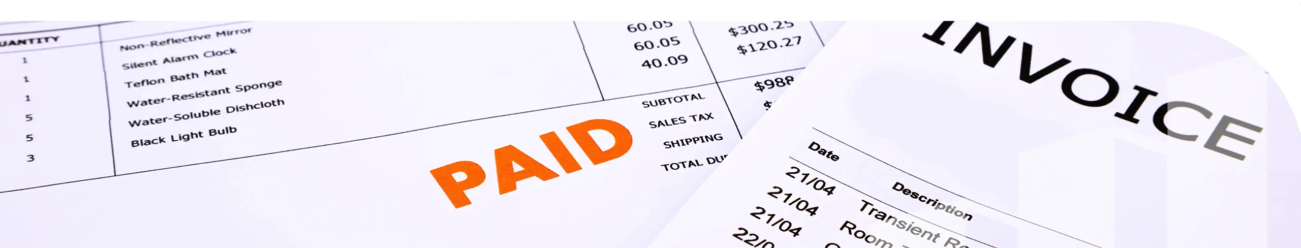 A stack of invoices with a paid stamp on one